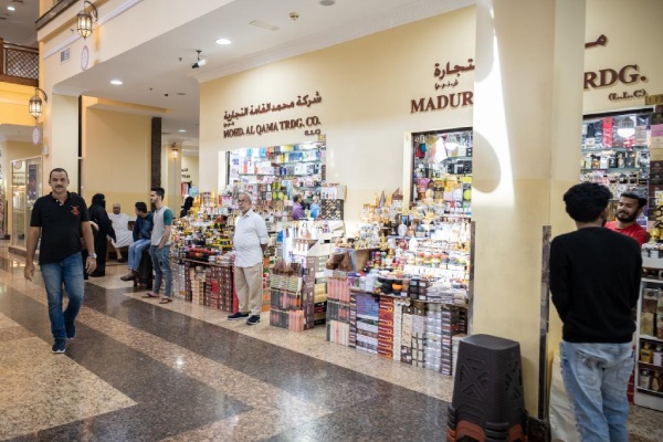 نمای داخلی بازار سوغاتی در دبی مال، یکی از جاهای دیدنی دبی با غرفههایی پر از محصولات متنوع و عطرهای سنتی.