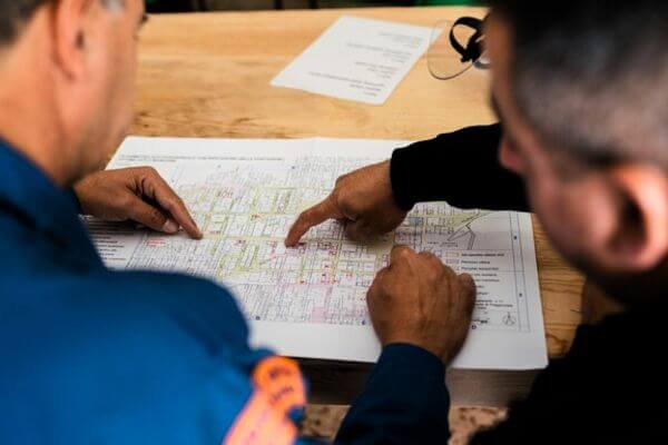 دو مهندس در حال بحث و بررسی نقشههای فنی - رشتههای مهندسی برای اپلای