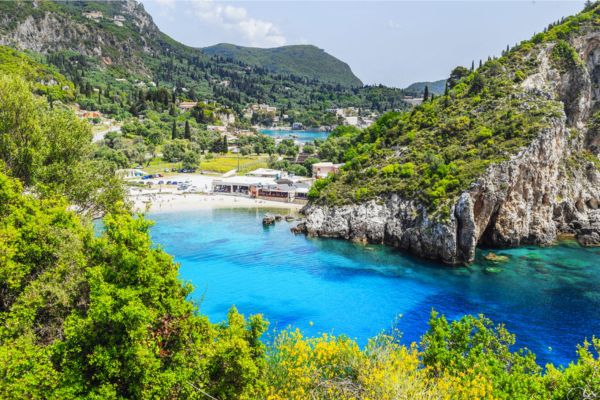 نمایی خیرهکننده از ساحل و طبیعت سرسبز جزیره کورفو در یونان با آبهای فیروزهای و صخرههای سنگی - یونان چند جزیزه دارد